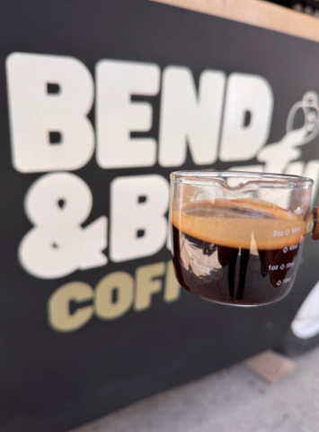 Espresso in front of the Bend & Brew Coffee Co. trailer logo