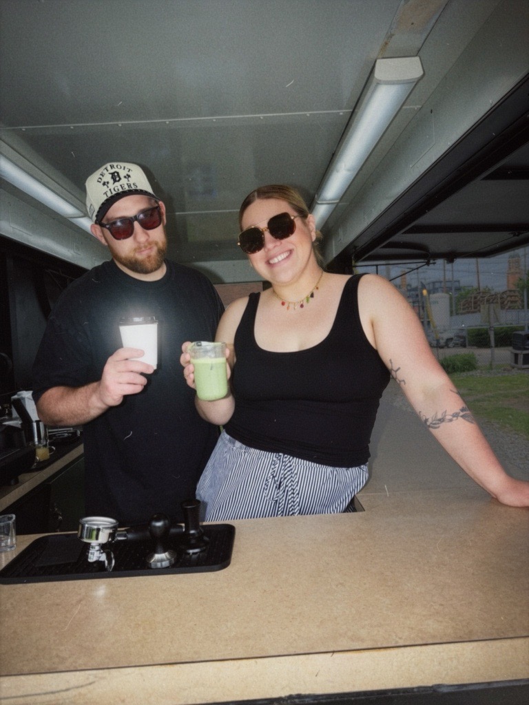 Bend & Brew team holding drinks at the coffee trailer counter